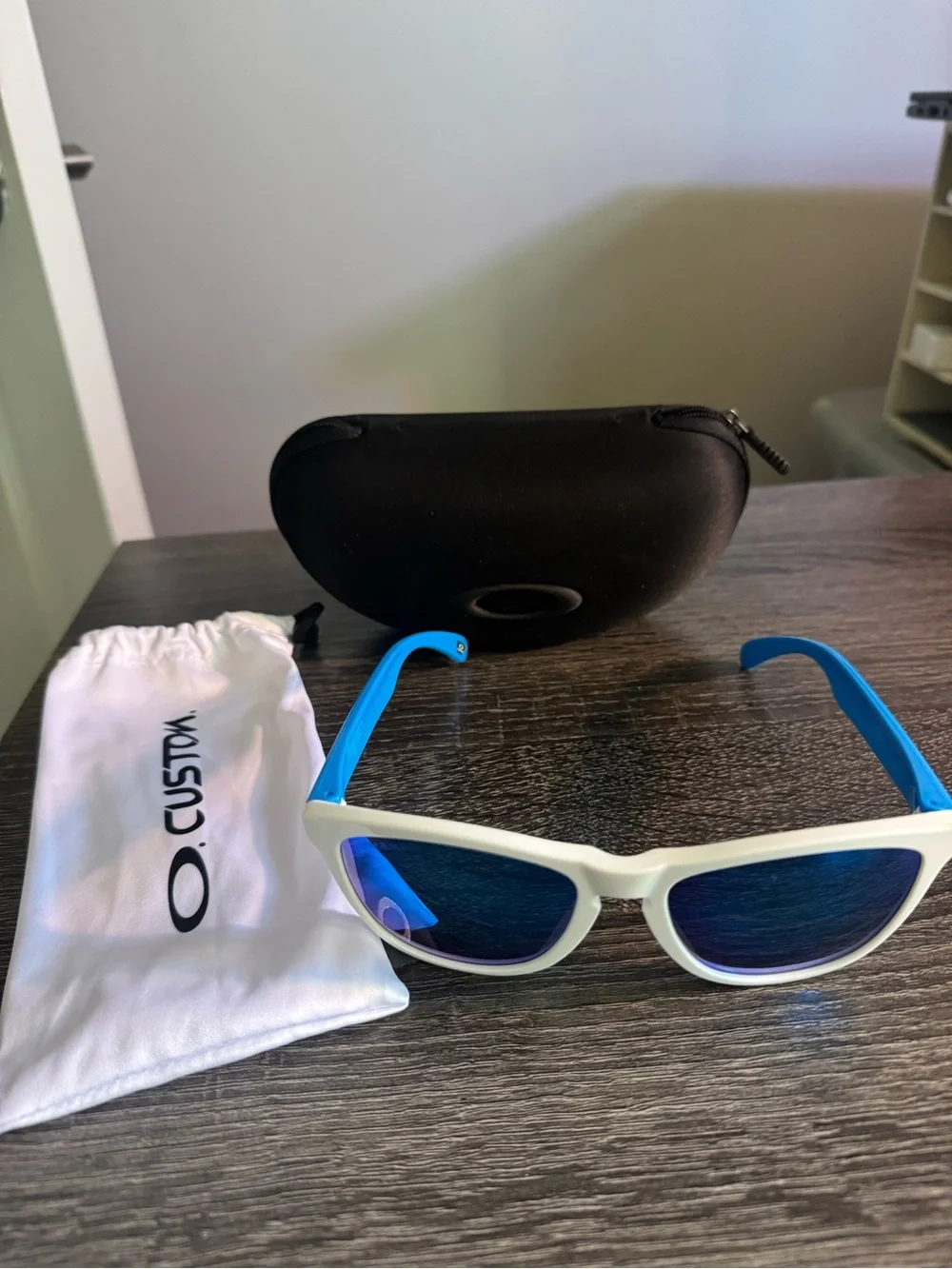 Oakley White Frame Sunglasses with Blue Mirrored Lenses